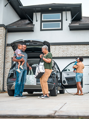 people unpacking a car