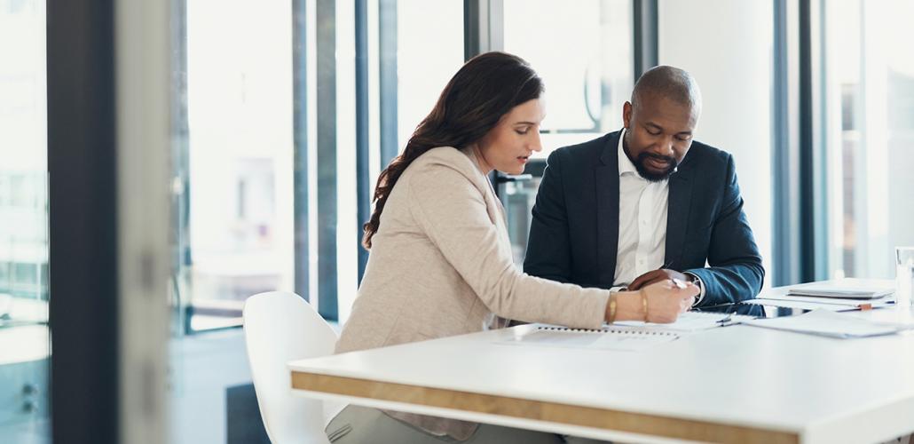man and woman working at a desk